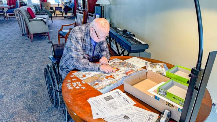Resident working on a puzzle in a common area