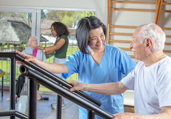 Therapist assisting a senior in a rehabilitation space