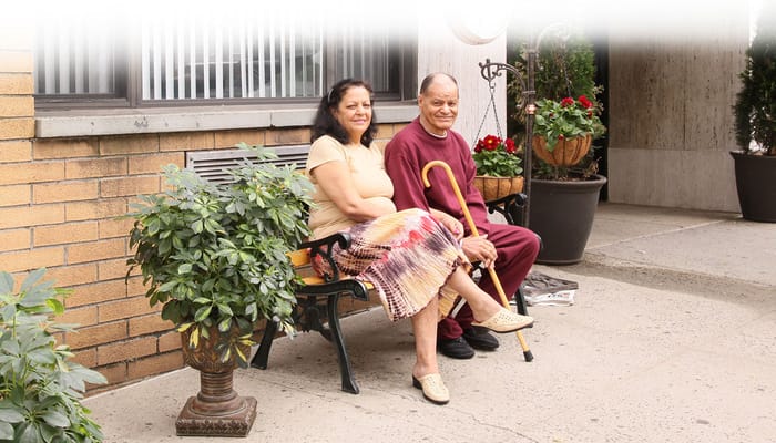 Residents enjoying time together outside on a bench
