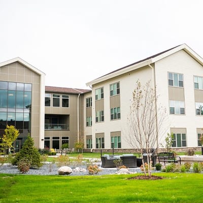Exterior view of a senior living facility with landscaped gardens