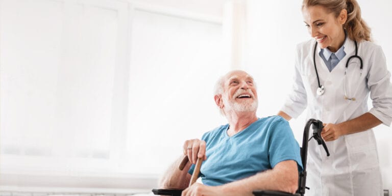 Healthcare professional assisting a smiling senior in a bright room