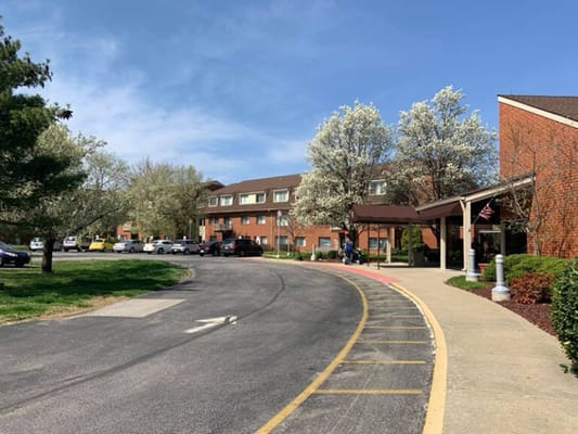 Exterior view of a senior living facility with trees