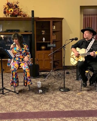 Performers entertaining residents in a lively activity room