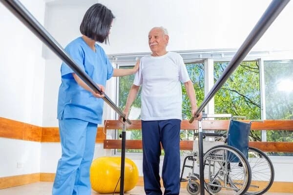 Therapist assisting a senior during rehabilitation