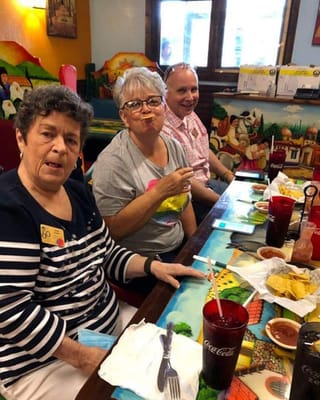 Residents enjoying a meal at a dining table
