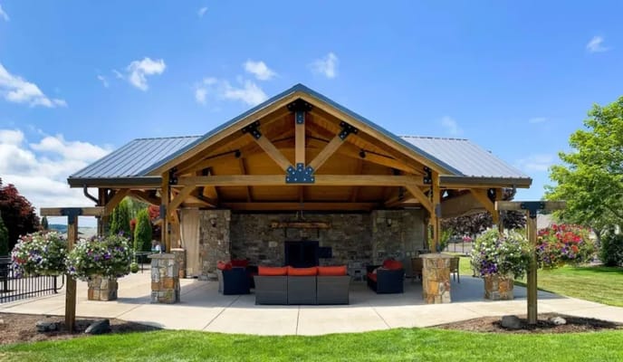 Outdoor seating area with a pavilion and landscaping