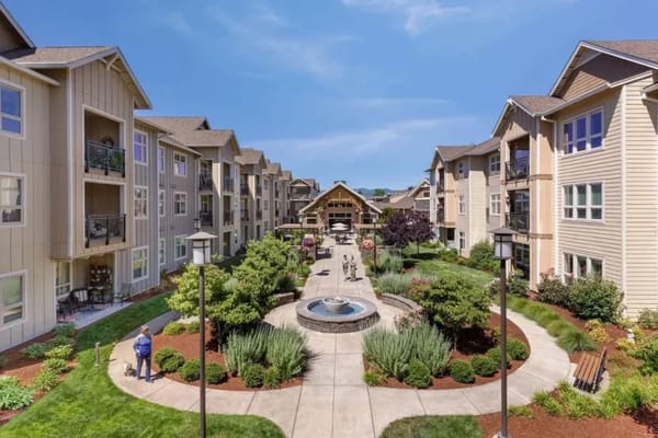 Beautiful garden courtyard with residents enjoying the outdoor space