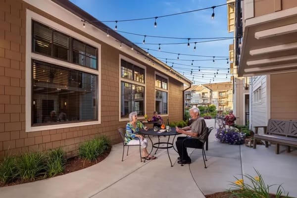 Seniors enjoying a drink in a garden area