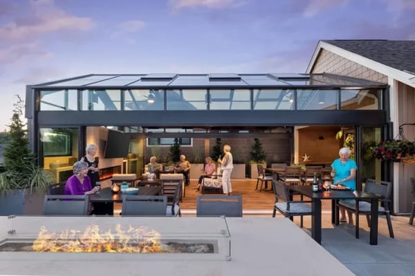Residents enjoying a social gathering in a sunny patio area