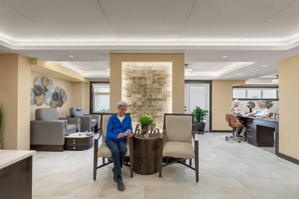 A resident enjoying a salon service in a bright interior