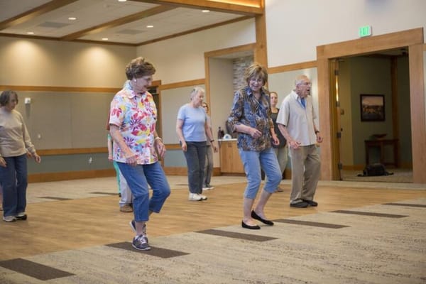 Residents participating in a dance activity in the common area