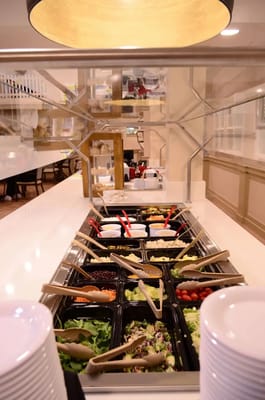 A vibrant salad bar with various toppings and ingredients