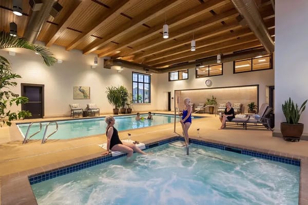 Residents enjoying the indoor swimming pool and spa area