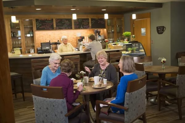 Residents enjoying coffee and pastries in a cozy lounge