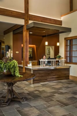 Reception area with staff member and decorative plants