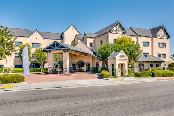Exterior view of a senior living facility with well-maintained landscaping