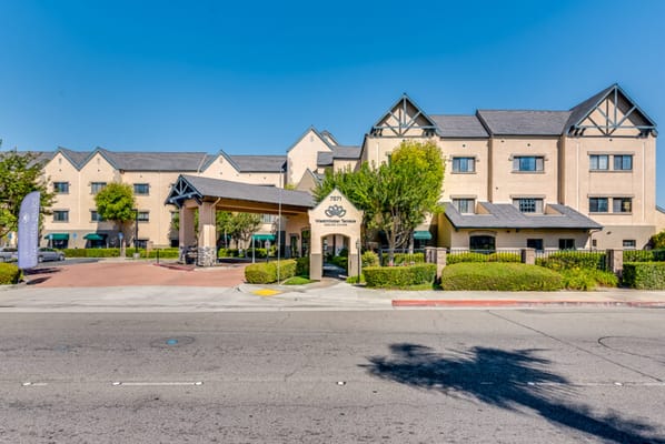 Front entrance of a senior living facility with green landscaping