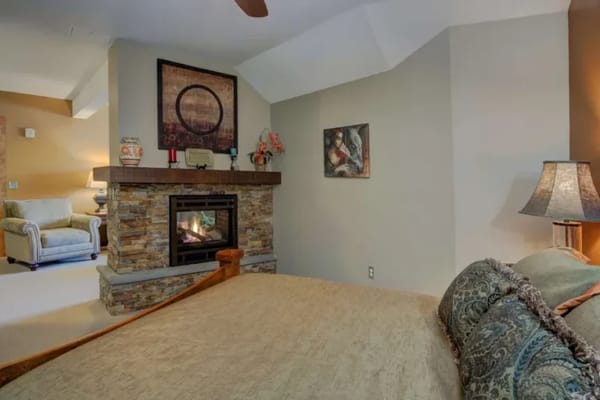 Cozy bedroom with a fireplace and comfortable furnishings