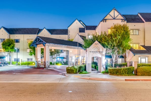 Exterior view of a senior living facility at dusk