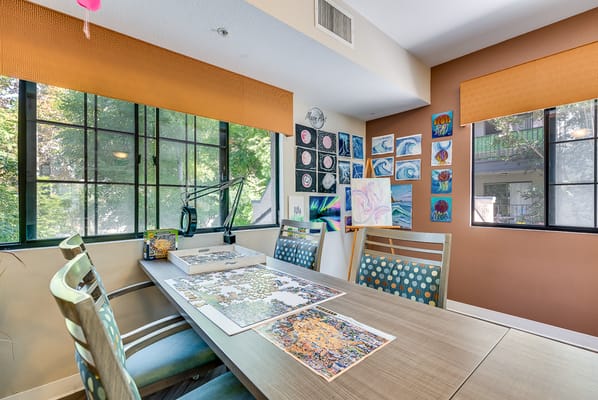 Bright activity room with art supplies and views