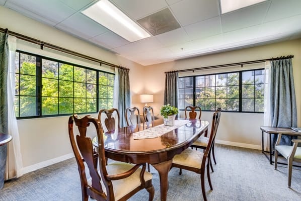 A bright dining room with a large wooden table