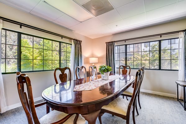 Bright dining area with large windows and wooden table