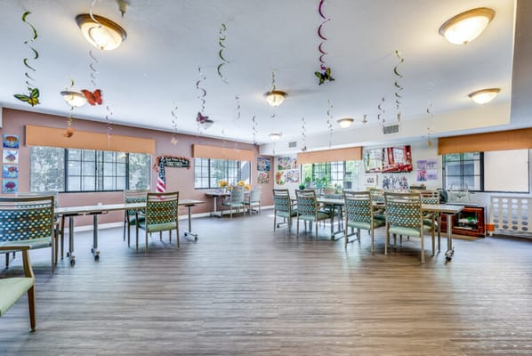 Bright activity room with tables and decorations