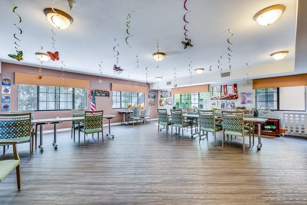 Bright activity room with tables and decorations