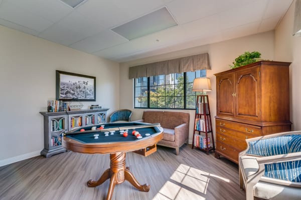 Interior activity room with a game table and seating