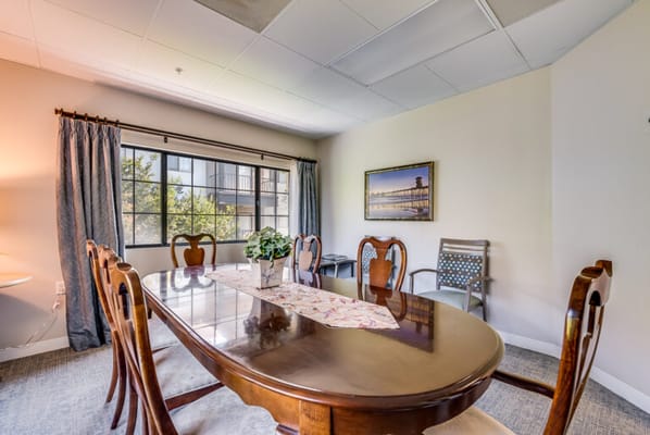 Bright dining area with large windows and wooden table