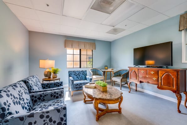 Bright common area with seating and a TV