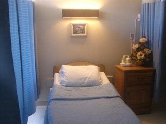 A cozy resident bedroom with blue curtains and decor