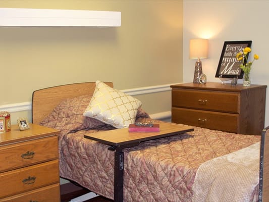 Cozy resident room with a bed and lamp