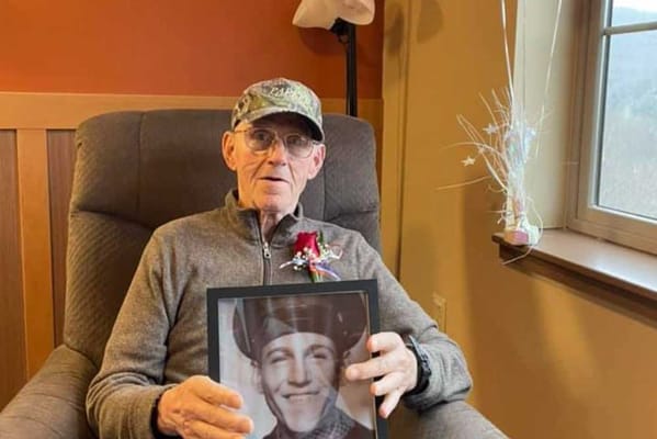 Senior resident holding a framed photo