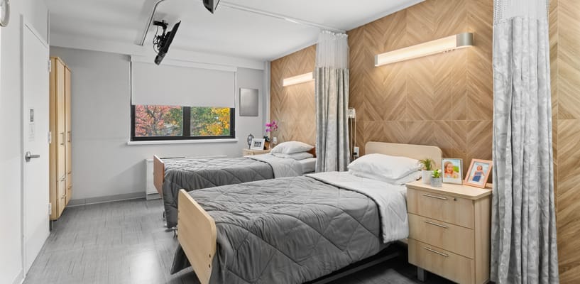 A cozy resident room with two beds and decor