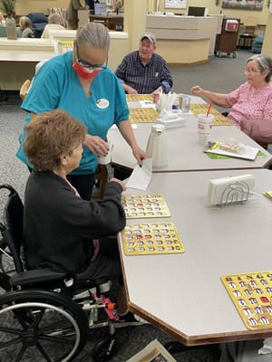 Residents engaged in a bingo game in a common area