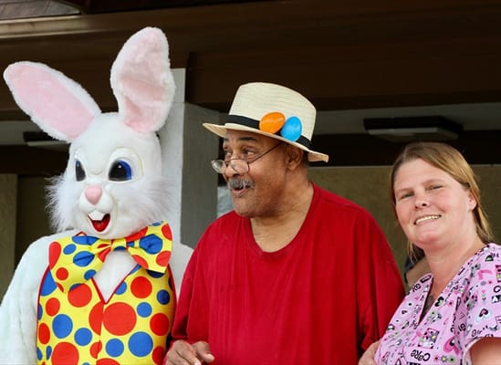 Resident celebrating with staff in festive costumes