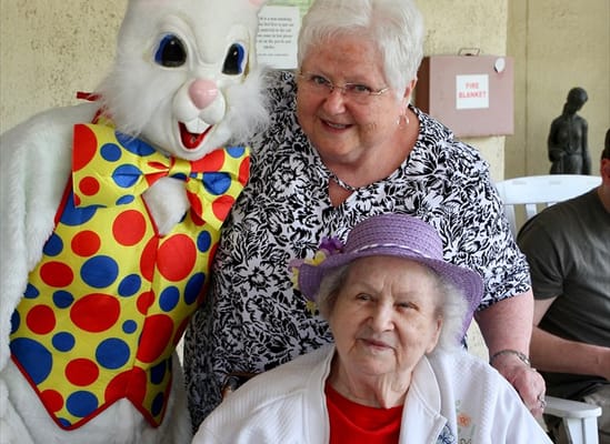 Residents celebrating with an Easter Bunny character