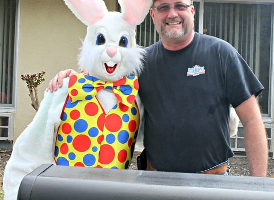 Resident and mascot posing together at an event