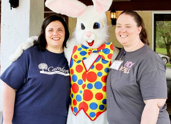 Two staff members posing with Easter Bunny mascot