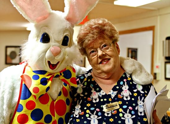 Resident posing with a costumed Easter Bunny