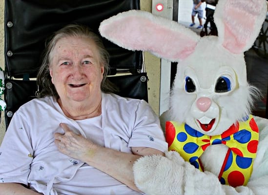 Resident and Easter Bunny at a celebration event