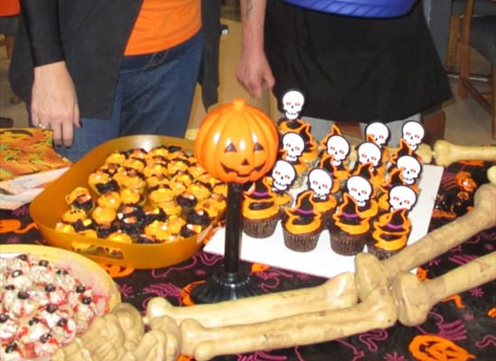 Residents enjoying Halloween-themed cupcakes and treats