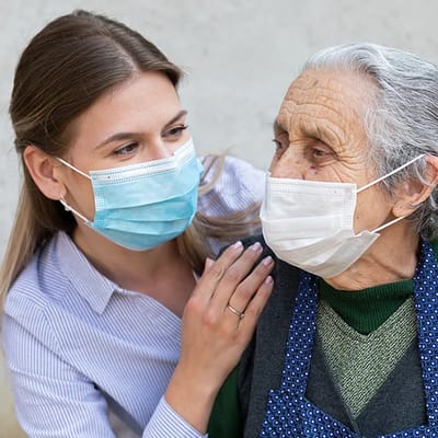 A caregiver interacting warmly with a senior resident