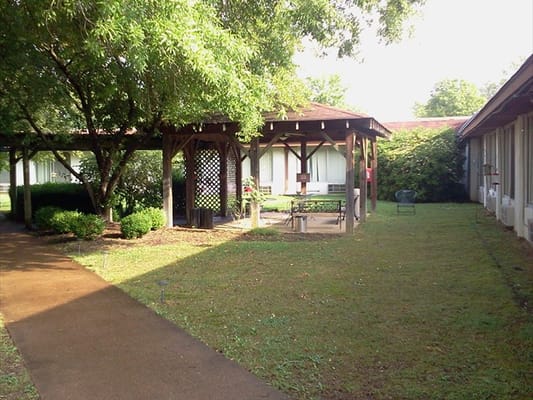 Outdoor space with shaded seating and greenery