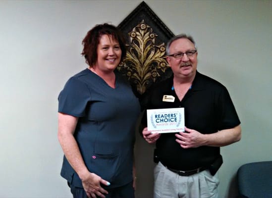 Staff receiving an award in a facility interior