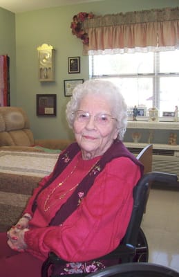 Elderly woman seated in a cozy interior setting