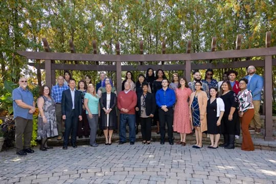 Staff and residents posing together in an outdoor setting
