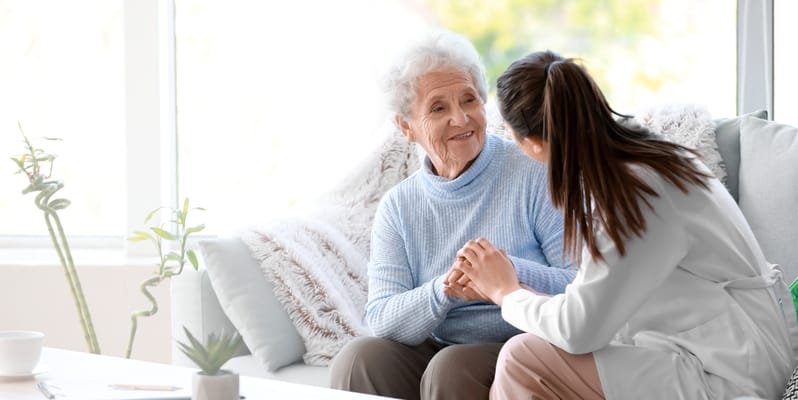 Caregiver interacting with a senior resident indoors