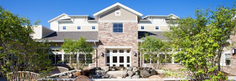 Exterior view of a assisted living facility with landscaped garden